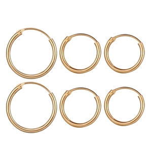 Three pairs of polished gold hoop earrings in small, medium, and large sizes