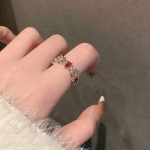 Elegant silver ring with rainbow rectangular zircons on finger for a stylish luxury look