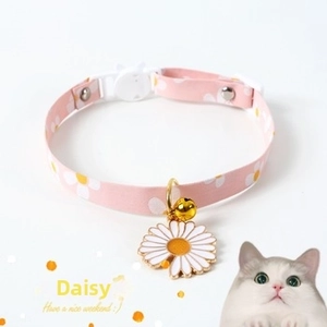 Pink fabric pet collar featuring white daisy patterns with gold bell and charm details