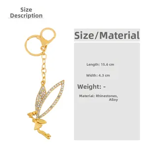 Golden fairy wing keychain with rhinestones showing 15.6cm length and 4.3cm width dimensions