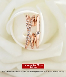 Close-up of rose gold adjustable layered ring with crisscross micro-pave diamonds