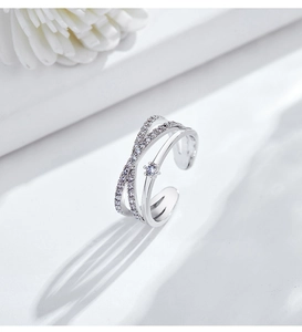 Detail of adjustable double-layer cross ring with pavé diamonds and starburst setting
