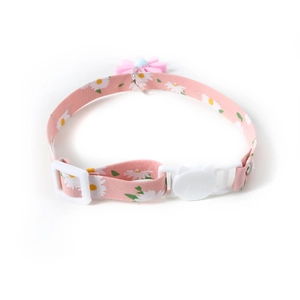 Detail of pink daisy pet collar showing polyester webbing and cat-shaped buckle