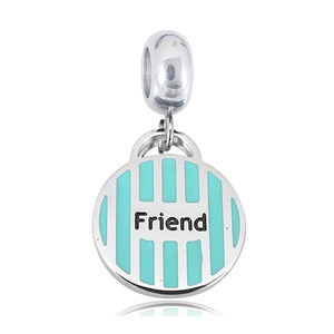 Macro shot of silver four-leaf clover charm with light blue enamel and Friend engraving