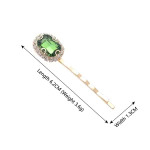 Vintage green crystal hair clip with rhinestones and gold wavy barrette frame, 6.2cm