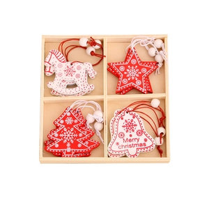Red and white Christmas wooden ornaments set in a wooden box with star and tree shapes