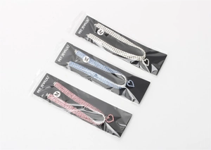 Detail view of M-sized rhinestone pet collar with heart pendant in pink, blue, and white