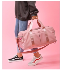 Close-up of a pink duffel bag with a dedicated shoe compartment for yoga and fitness