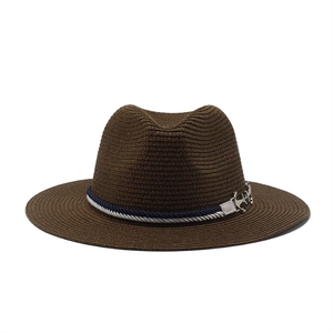 Close-up of brown straw fedora hat featuring a nautical rope band and silver anchor charm