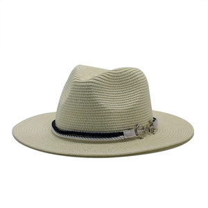 Detail of nautical wide brim straw hat with rope band and silver anchor charm