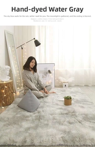 Detailed view of tie-dye water gray plush carpet with soft long-fiber shaggy texture