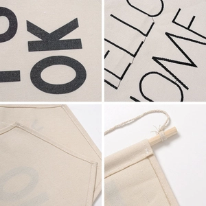 Beige canvas wall banner for pin collection with wooden rod and graphic prints