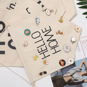 Hanging canvas banner for enamel pins with wood pole and Hello Home printed text