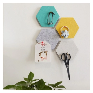 Hexagonal felt wall tiles in blue, yellow, and grey for creative home decor and storage