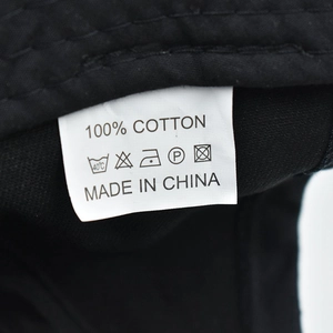 Detailed macro shot of the 100% cotton washing label and inner fabric of the ponytail cap