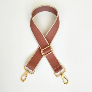 Detail of adjustable 3.8cm canvas bag strap with golden buckles in dusty rose pink