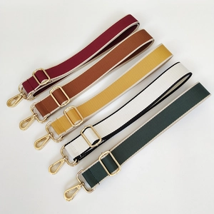 Detail of adjustable 3.8cm woven bag straps in various colors with gold metal hooks
