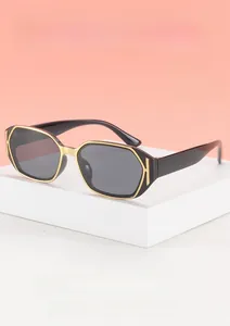 Detail of vintage square sunglasses with gold metal edges on a geometric pedestal
