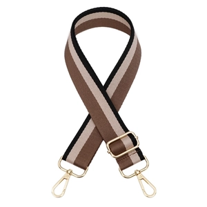 Detail of adjustable thickened striped canvas bag strap with golden metal lobster clasps