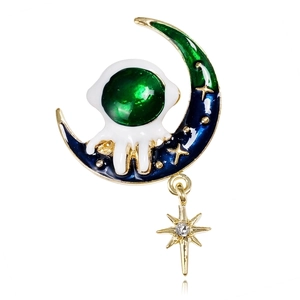 Detail of astronaut on blue crescent moon brooch with hanging gold star pendant