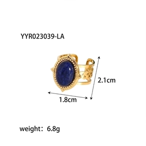 Detail view of vintage gold ring with oval blue natural stone and hollow woven texture