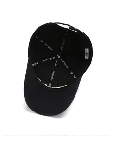 Detail view of cotton baseball cap interior featuring branded tape and metal buckle