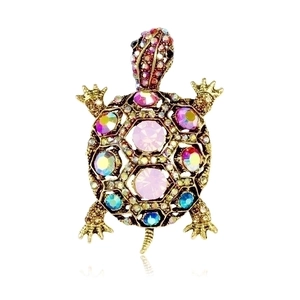 Detailed macro shot of vintage turtle brooch with colorful rhinestones on golden base