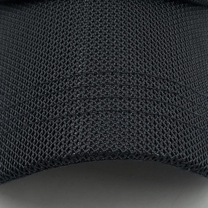 Close-up of black mesh fabric showing breathable honeycomb structure of the baseball cap