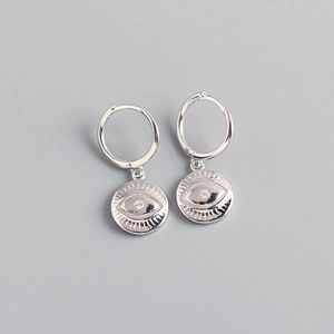 Macro shot of silver evil eye hoop earrings with sparkling crystal center detail