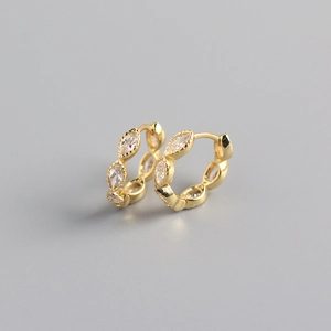 Macro view of gold hoop earrings with marquise-cut crystals in a minimalist design