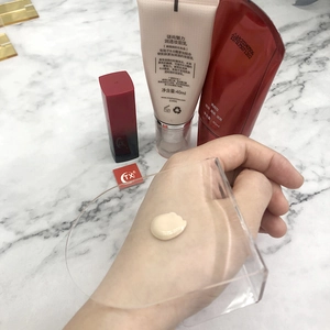 Macro view showing creamy texture of makeup primer on a clear acrylic palette