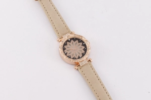 Detailed macro view of starry sky watch with rose gold bezel and hollow floral pattern