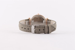 Detail of grey suede leather watch strap with rose gold pin buckle on display stand