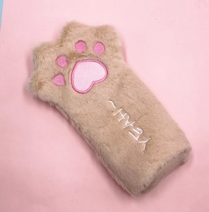Detail of plush cat paw pencil case with embroidered pink pads and YEAH text
