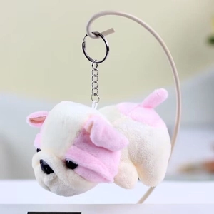 Detail shot of a plush bulldog keychain accessory with soft texture and metal ring