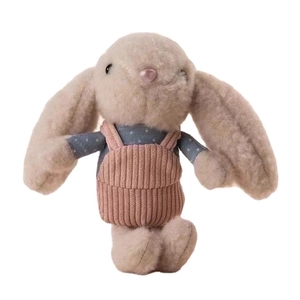 Cute long-eared plush rabbit wearing blue polka dot shirt and pink corduroy overalls