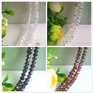 Detail of faceted AB crystal glass beads in transparent white and violet for DIY jewelry