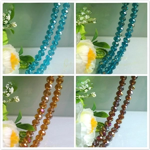 Detailed macro of faceted crystal beads in royal blue, peacock blue, and amber with AB coating