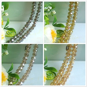 Macro shot of faceted crystal beads in grey, yellow, and champagne with AB coating