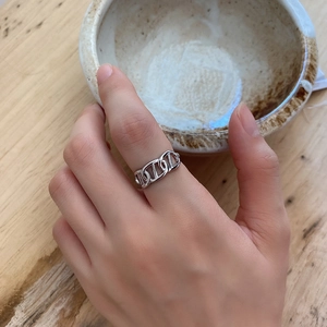 Detailed view of an 925 sterling silver anchor chain ring worn on a finger