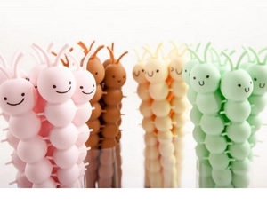 Close-up of colorful cartoon elk silicone pens in pink, brown, yellow, and green