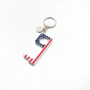 Detail of acrylic no-touch door opener tool with American flag pattern and keyring