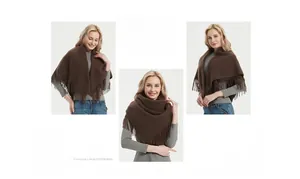 Detail of dark brown knitted shawl showing tassel texture and thick winter fabric drape