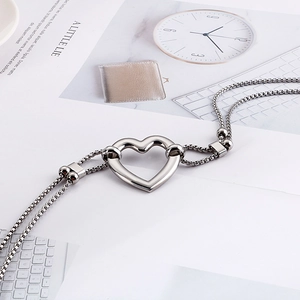 Polished stainless steel double box chain necklace featuring a hollow heart centerpiece