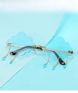 Detail of cloud-shaped rimless sunglasses with blue raindrop charms and gold metal frame