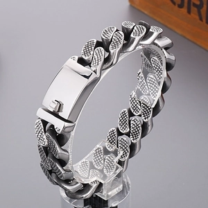 Detailed close-up of textured stainless steel links on a vintage silver Cuban bracelet