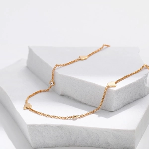 18K gold plated necklace with heart pendants and crystals on white stones