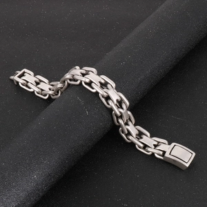 Close-up of masculine silver stainless steel chain link bracelet with fold-over clasp
