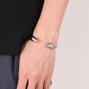 Polished stainless steel open cuff bracelet featuring double dolphin heads for men