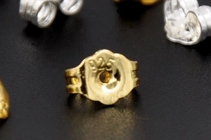 Macro shot of 925 stamped butterfly earring back in 18K gold plated silver finish